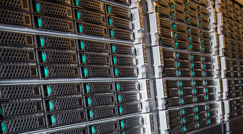 a close up of many rack mounted servers in a supercomputer cluster